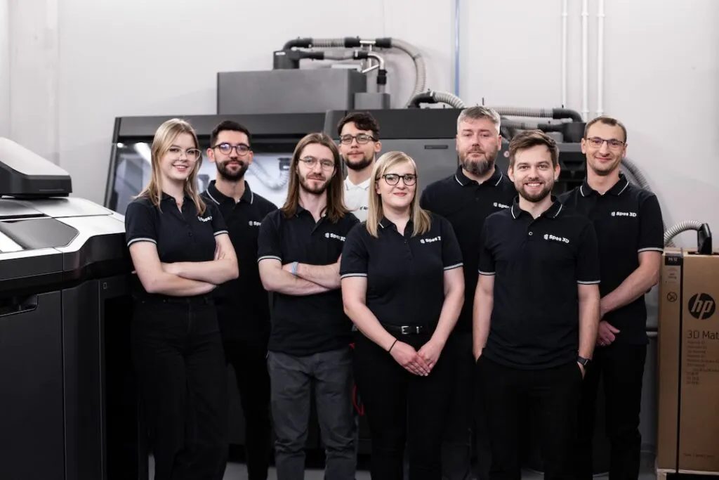 Spes3D team of engineers and specialists posing in the machine park in front of industrial 3D printers – experts supporting 3D project fulfillment.